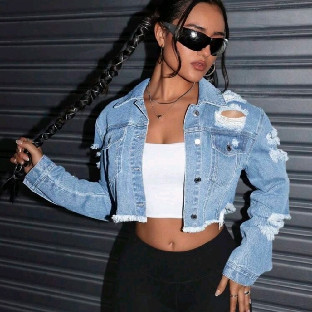 Trendy light blue denim jacket with distressed details. Perfect for casual outin
